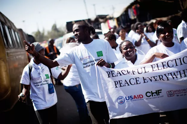  Kenyan youth marching to elevate community cohesion networks before general elections in March 2013.